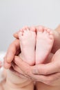 FatherÃ¢â¬â¢s hands holding newborn baby feet. Closeup feet of newborn baby. Healthcare, medical, love and fatherÃ¢â¬â¢s day background Royalty Free Stock Photo